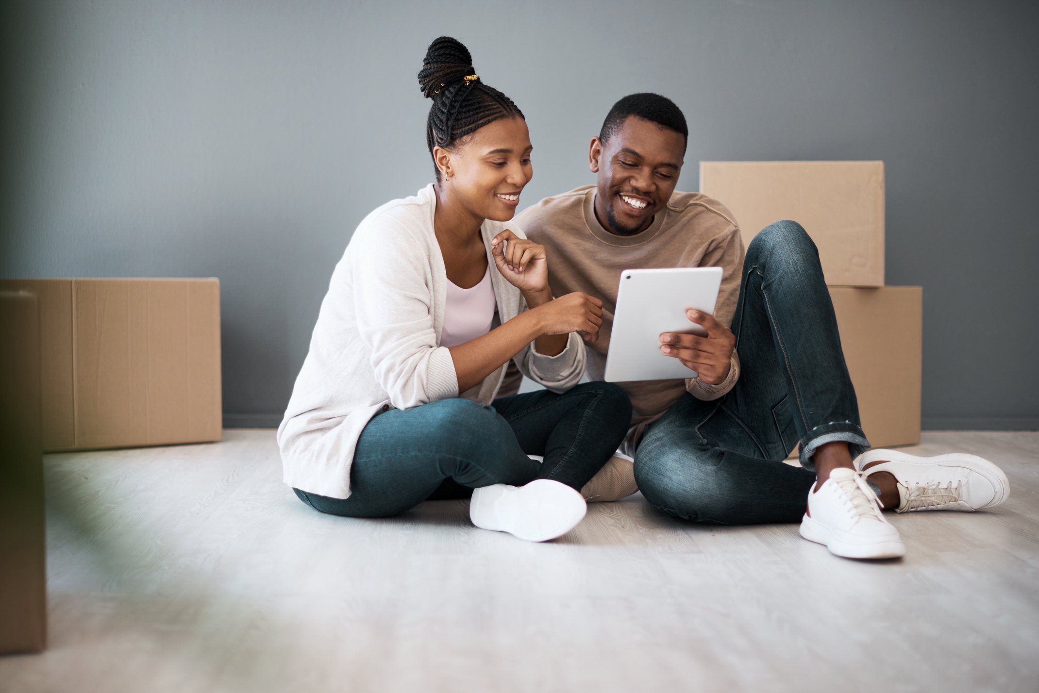 Tablet, Box and Moving with Black Couple in New House for Planning, Real Estate and Property. Investment, Goals and Future with Man and Woman in New Home with Technology, Internet and Growth